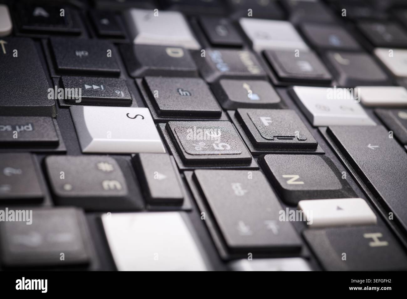 Close-up of a collection of keyboard keys from different old laptops on a table Stock Photo