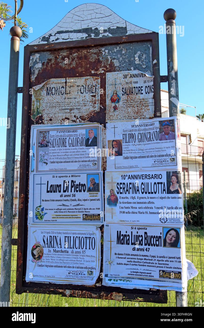 Bereavement and funeral notices displayed on a public notice board in a north-east Sicily village, Italy. Stock Photo