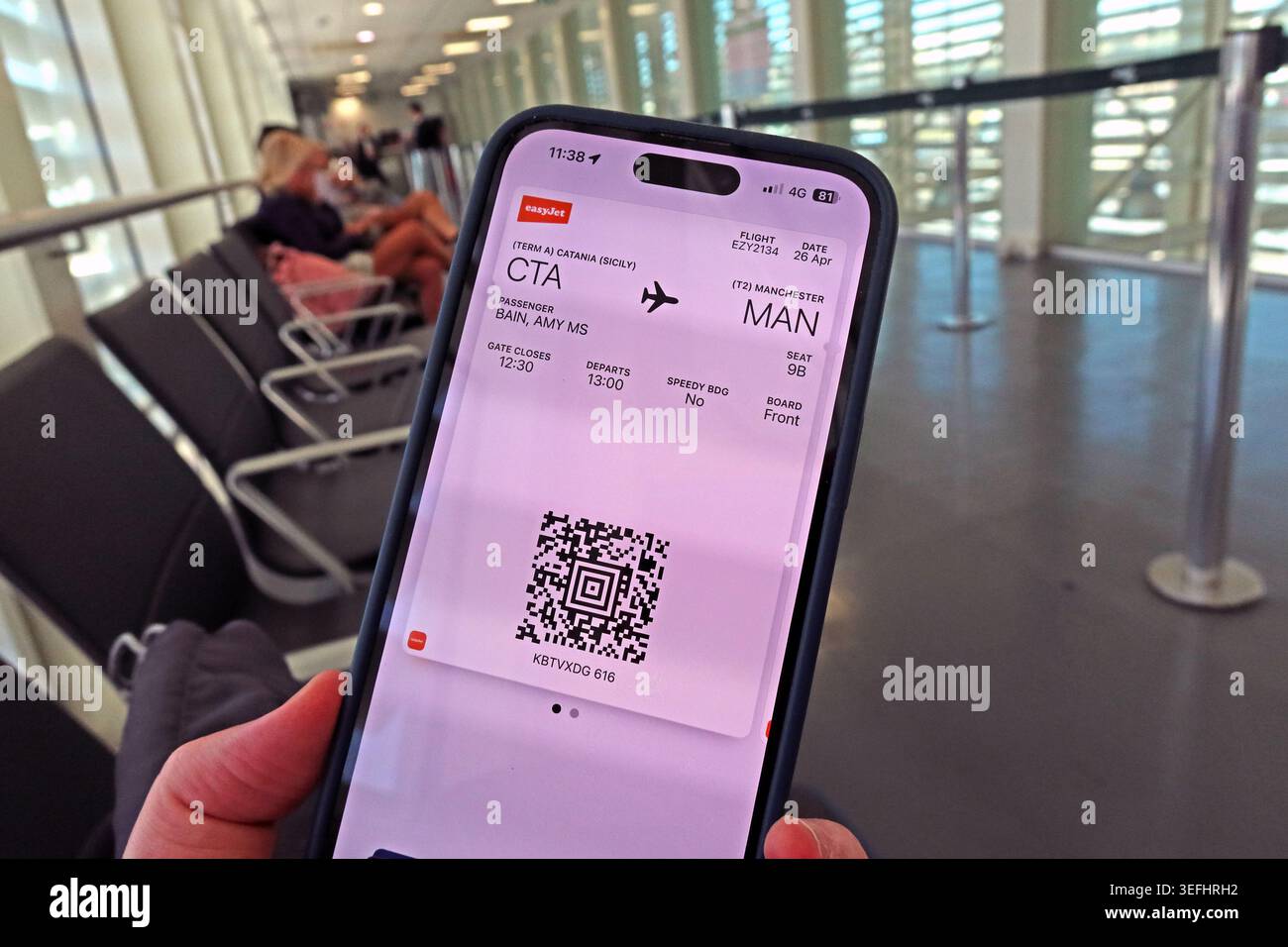 easyJet mobile boarding pass for a Catania to Manchester flight displayed on a smartphone at an airport. Stock Photo
