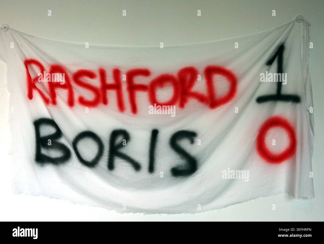 Marcus Rashford v Boris Johnson food poverty banner at Old Trafford, Manchester, during lockdown, UK. Stock Photo