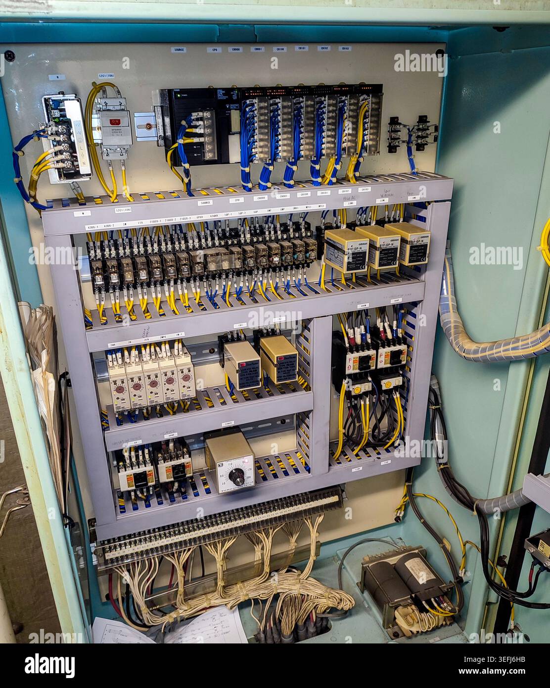 Detailed internal look at complex rows of relays, terminals, electronic ...