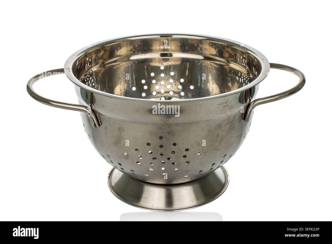 Metal colander isolated on white background, close-up. Stock Photo