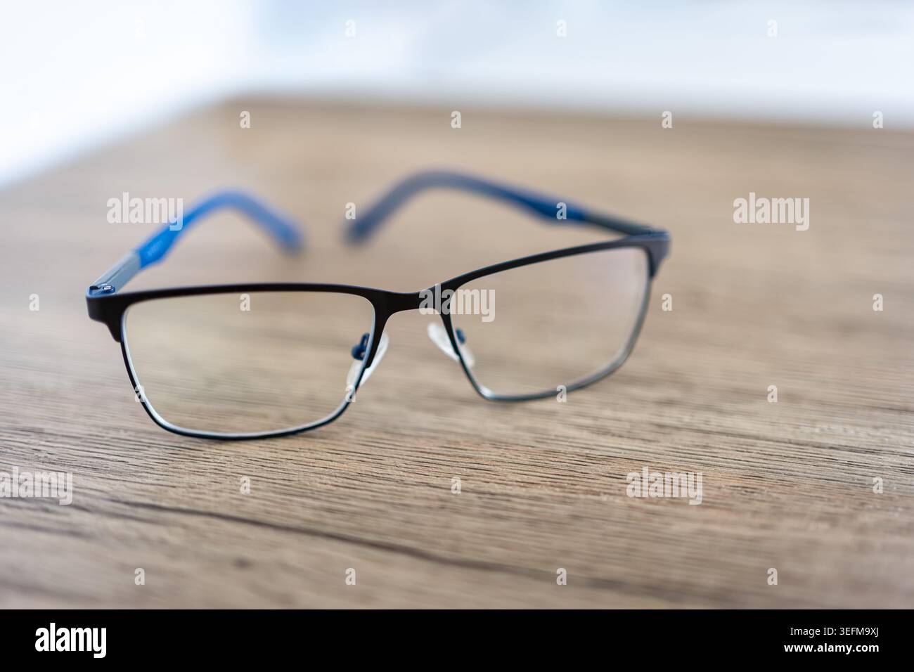 Reading glasses on wooden table. Stock Photo