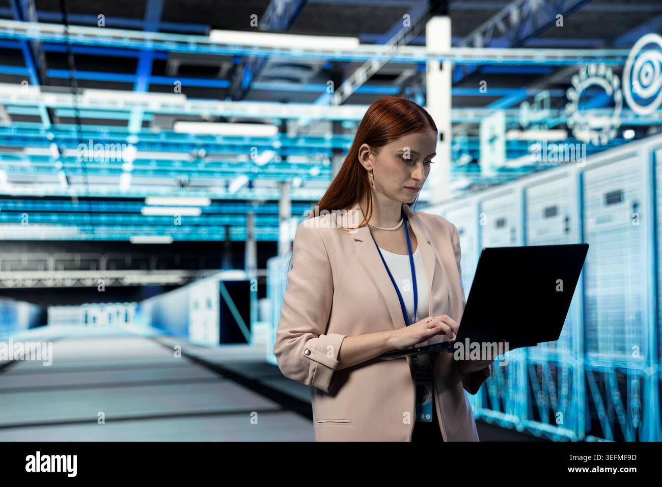 Data center engineer managing infrastructure systems for uptime and efficiency using laptop. Server room IT professional upgrading enterprise networks hardware using notebook Stock Photo