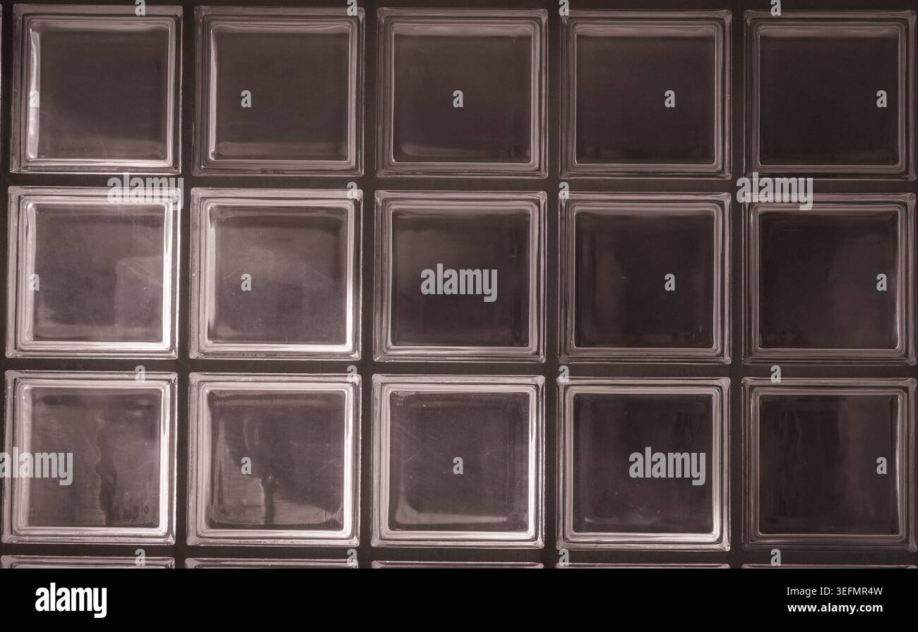 Glass block wall pattern creating abstract background with light Stock Photo