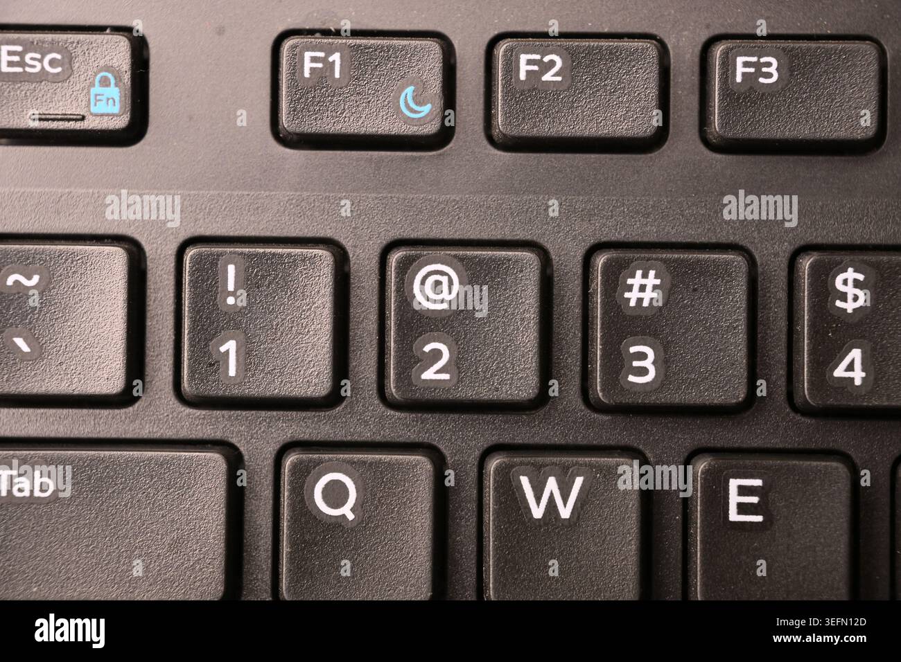 Black Computer Keyboard Macro Shot Highlighting 2 and At Symbol Key with Soft Blurred Backgrounds Top View Stock Photo