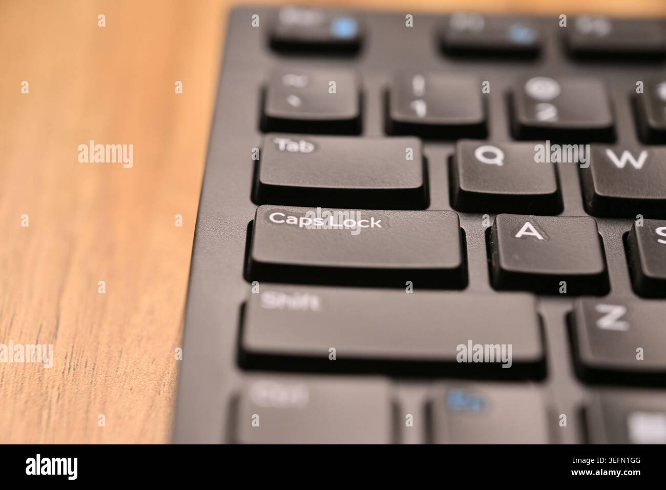 Black Computer Keyboard Macro Shot Highlighting Caps Lock Key with Angled Top View and Soft Blurred Backgrounds Stock Photo