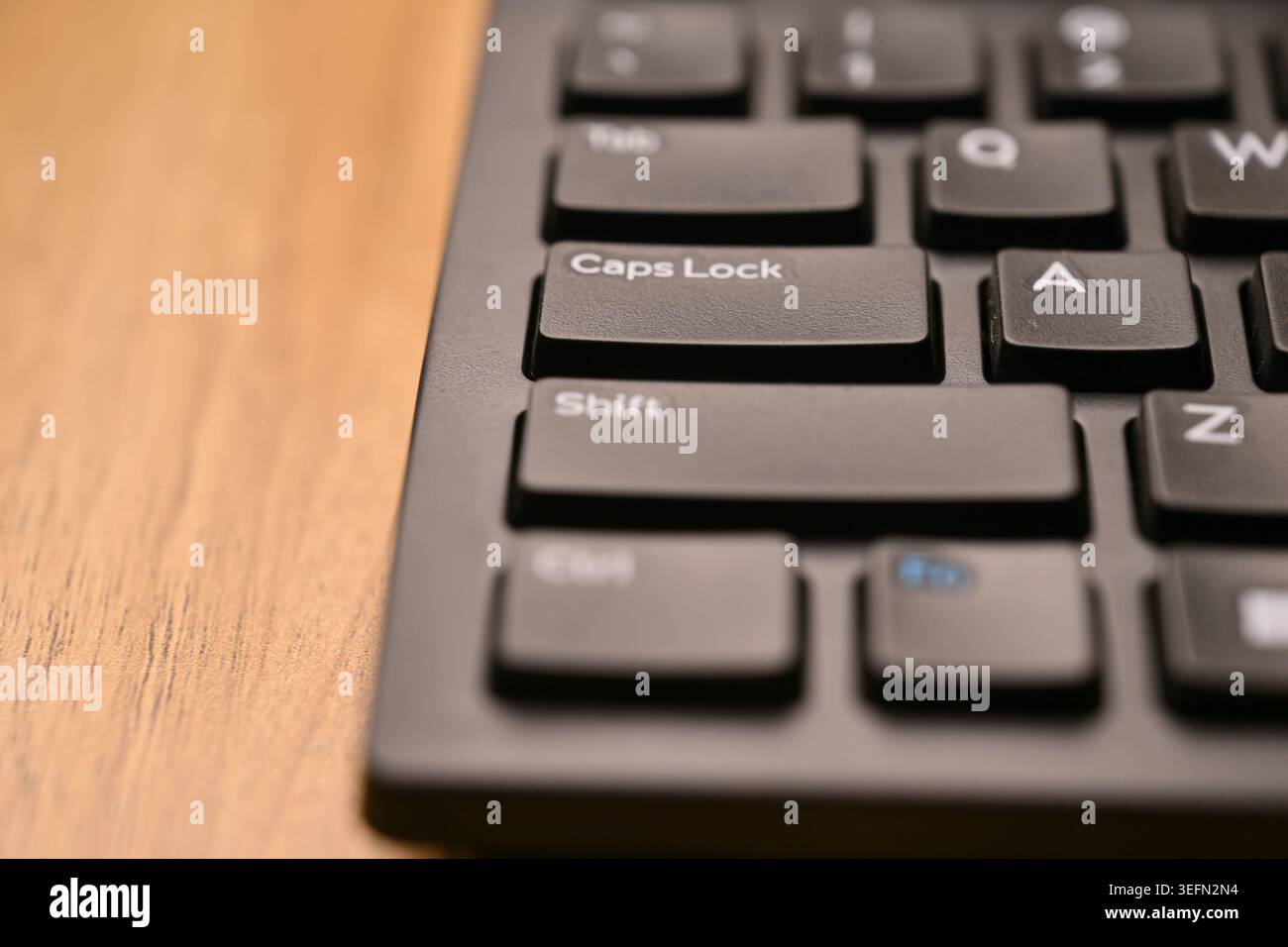 Black Computer Keyboard Macro Shot Highlighting Caps Lock Key with Soft Blurred Backgrounds Angled Top View Stock Photo