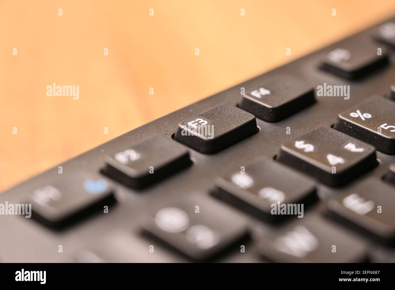 Macro Angled Top View Black Computer Keyboard Highlighting F3 Function Key on Blurred Tech Backgrounds Stock Photo