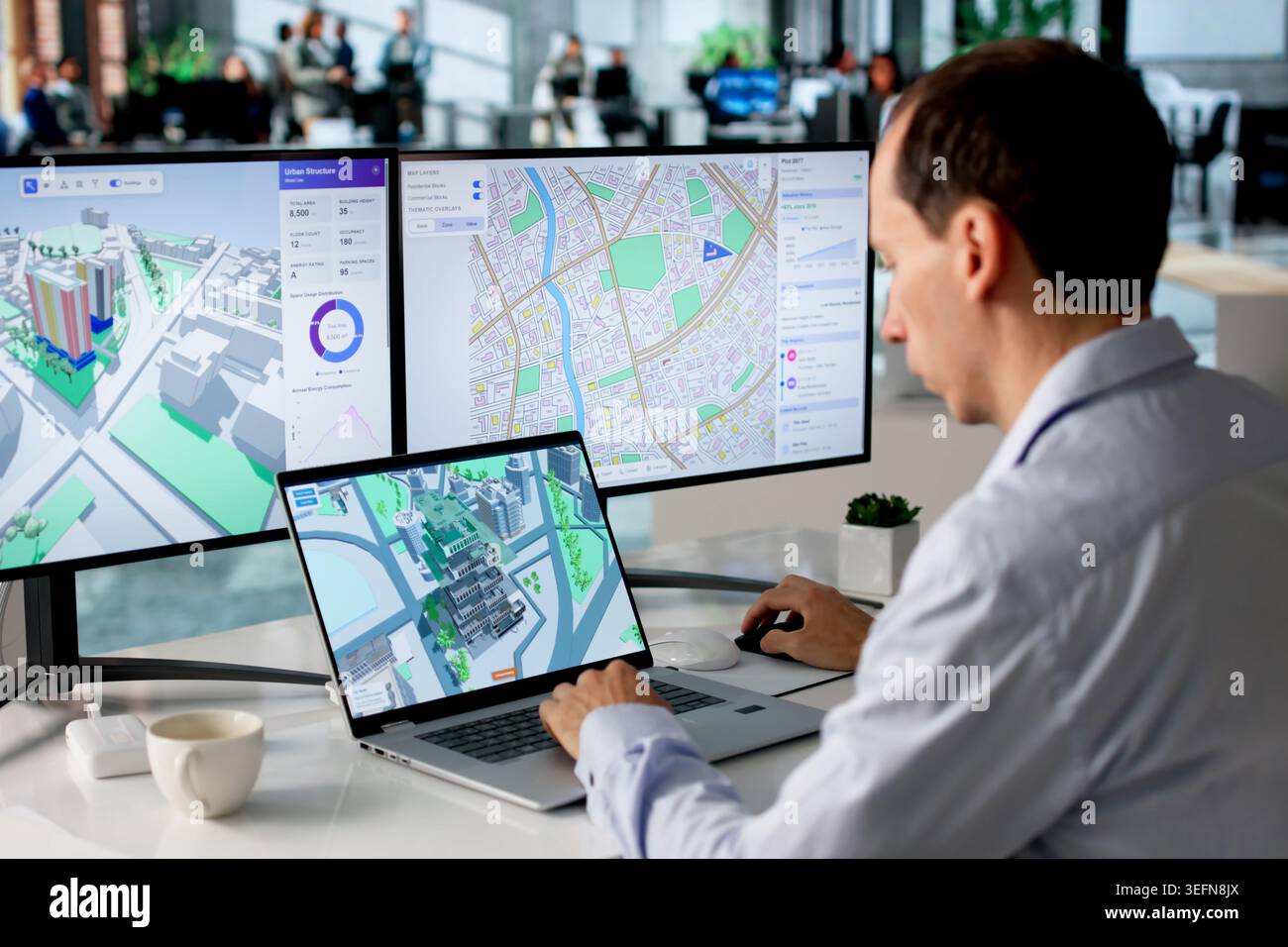 Engineer Studies Urban Property Maps On Laptop Using BIM And GIS Software. Stock Photo