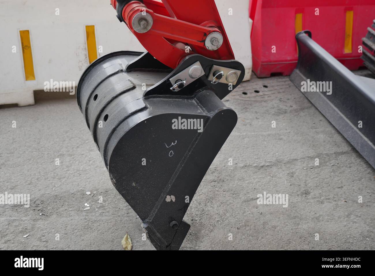 Excavator bucket attachment on construction site Stock Photo