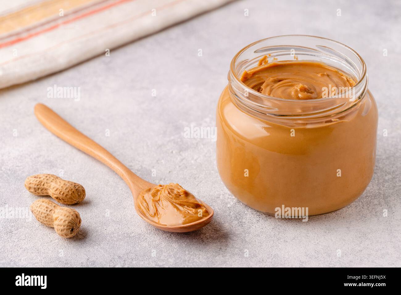 Peanut paste in an open jar Stock Photo
