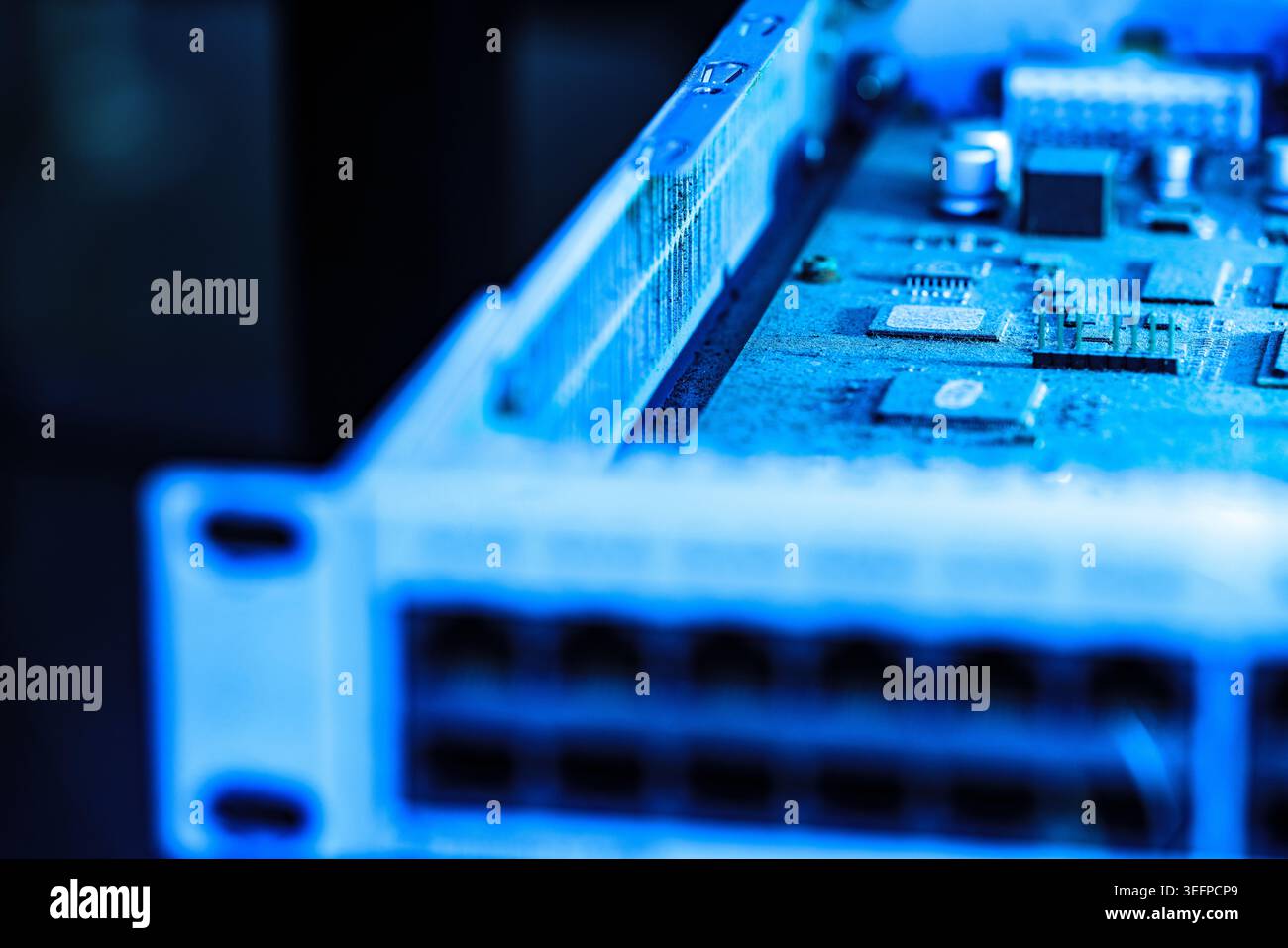 This detailed image showcases a computer motherboard with various electronic components, microchips, and circuit pathways, emphasizing modern digital Stock Photo
