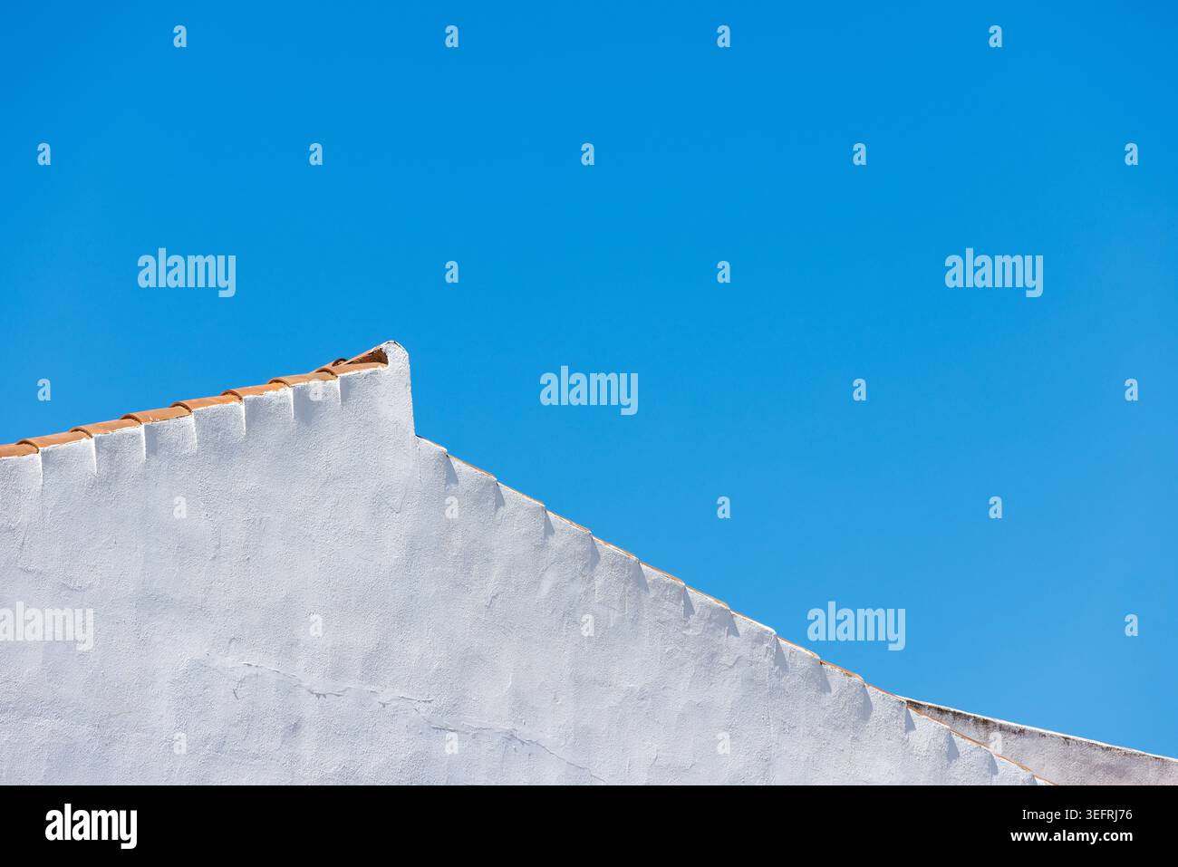 Blue Sky and White Painted House Wall Background Texture. Stock Photo