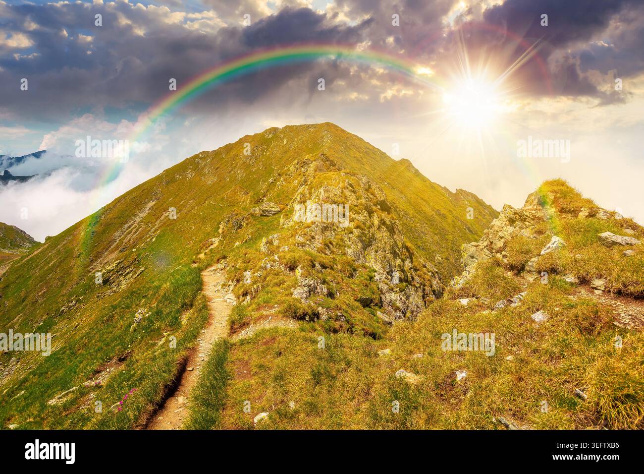 sunset over mountain scenery in summer. gorgeous mountainous landscape. background with rocky cliffs and grassy hillsides under a cloudy sky. ridge of Stock Photo