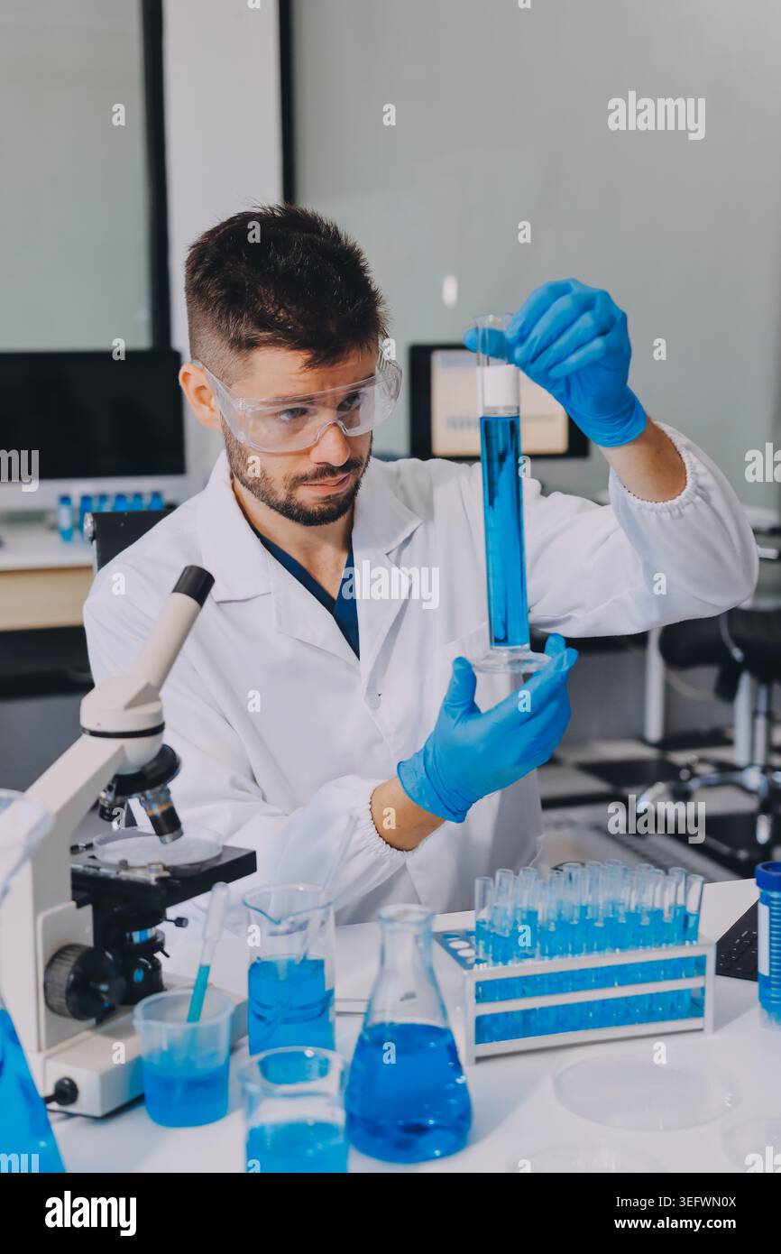 Lab technician experimenting in lab Stock Photo