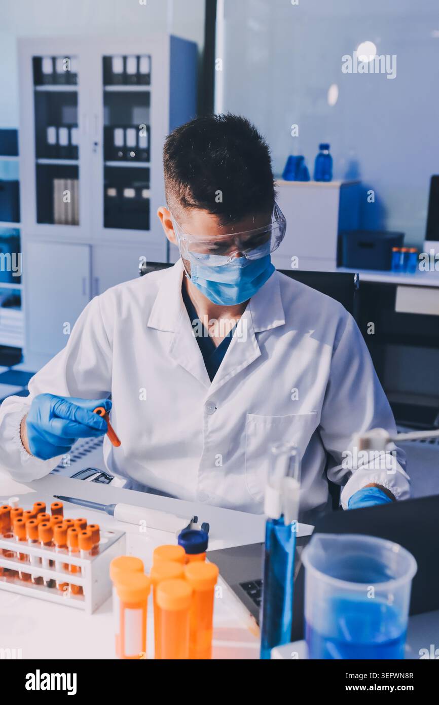 Lab technician experimenting in lab Stock Photo