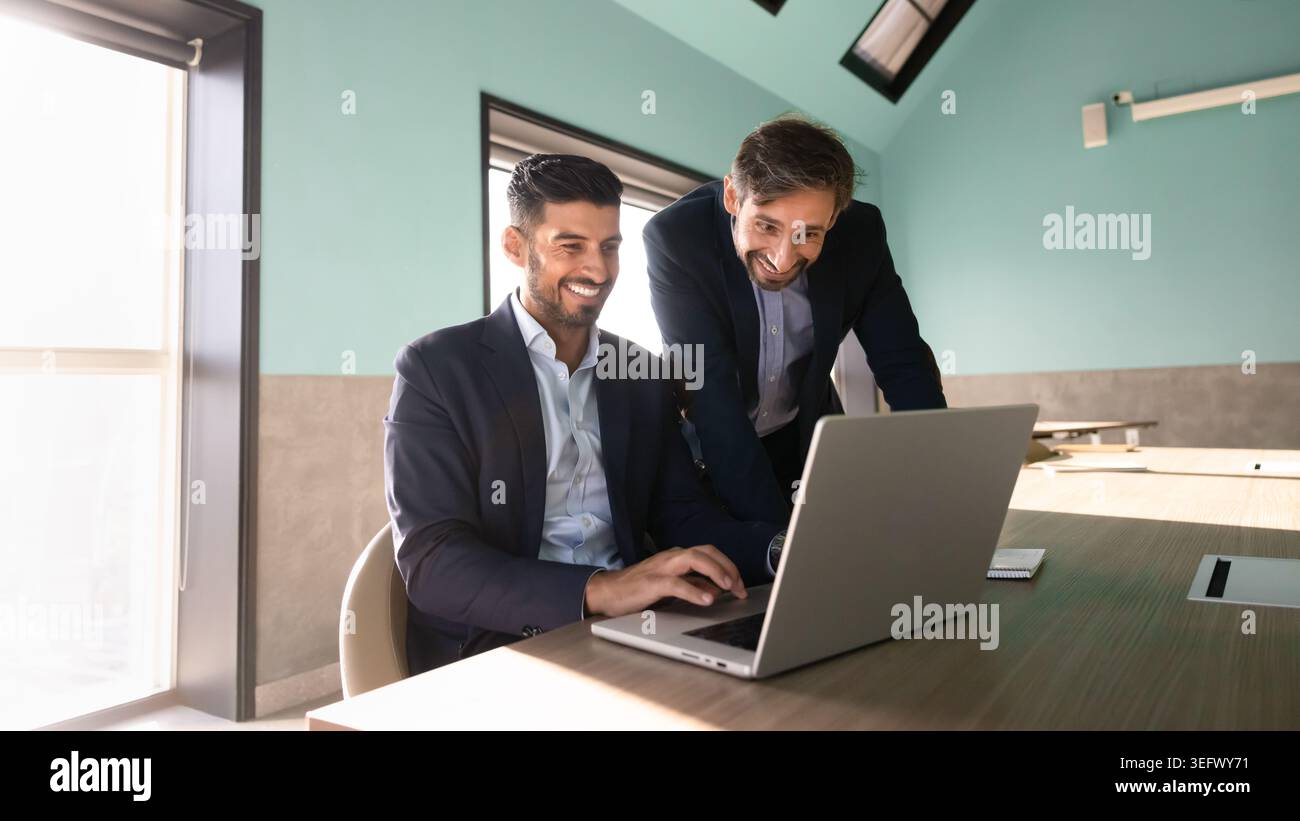 Colleagues working on laptop engage in project management in office Stock Photo