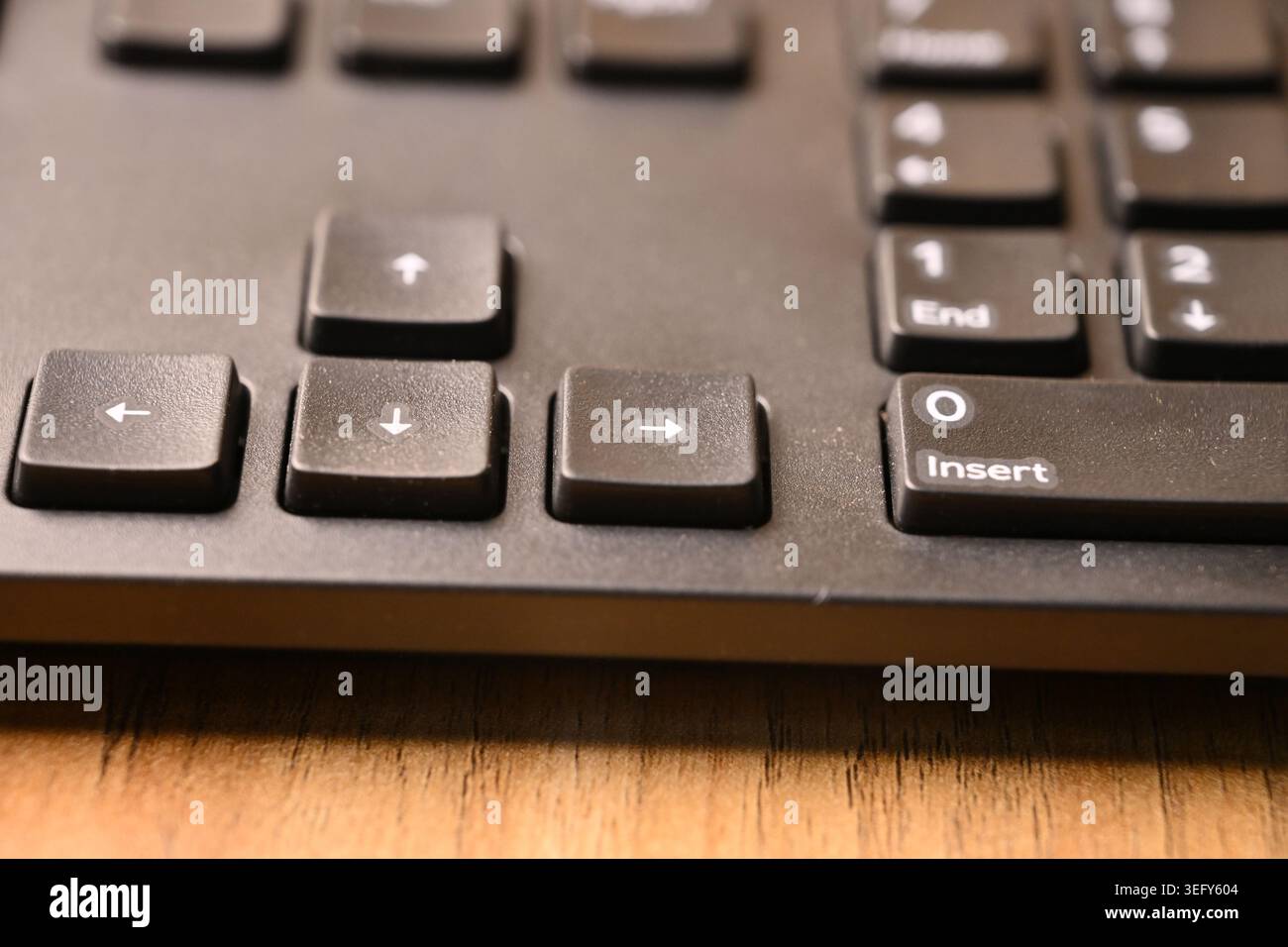 Angled Top View Macro Close-Up Black Computer Keyboard Highlighting Right Arrow Key on Blurred Tech Backgrounds Stock Photo