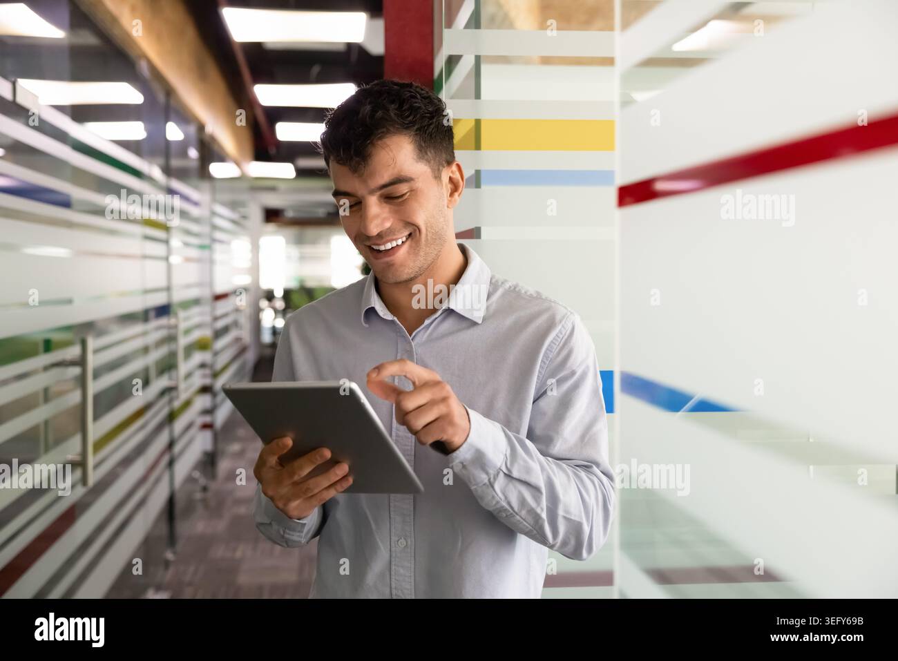 Smiling businessman working online using digital tablet Stock Photo