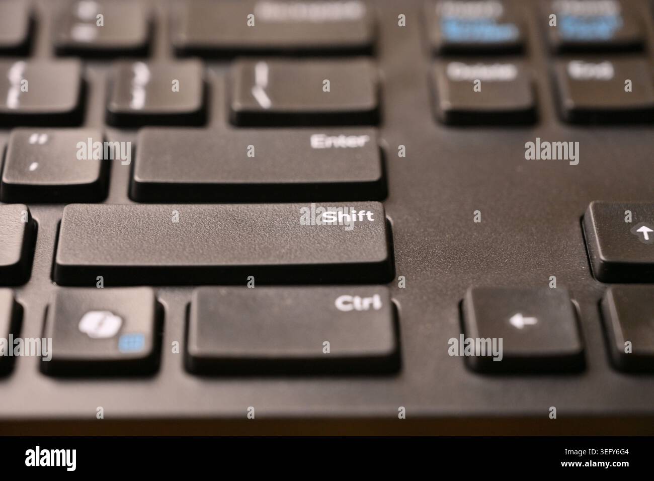 Black Computer Keyboard Macro Shot Highlighting Shift Key with Soft Blurred Backgrounds Angled Top View Stock Photo
