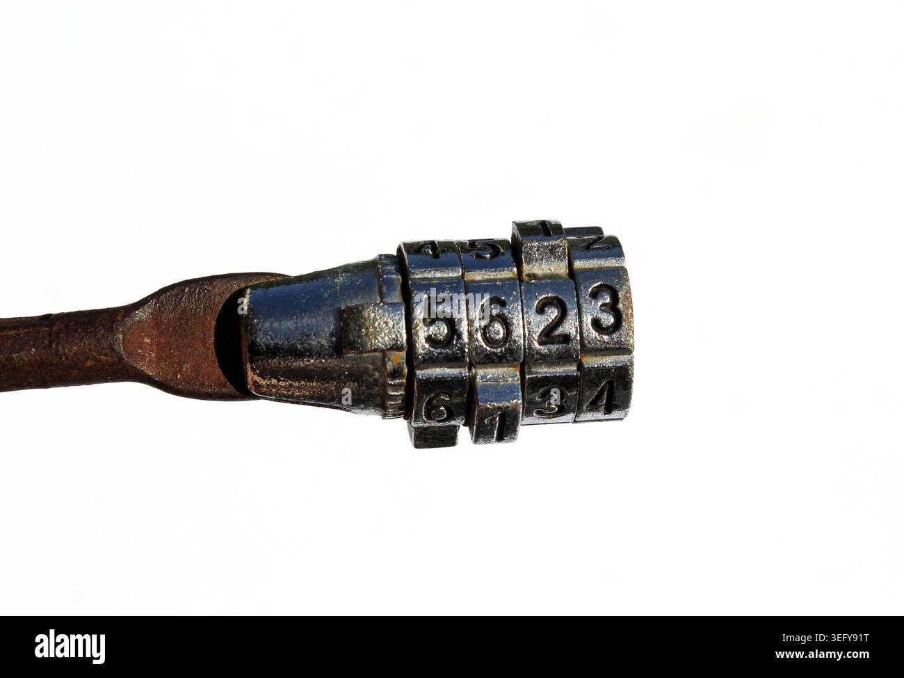 A close-up of a rusty metal combination bike lock with numbers on a plain white background Stock Photo