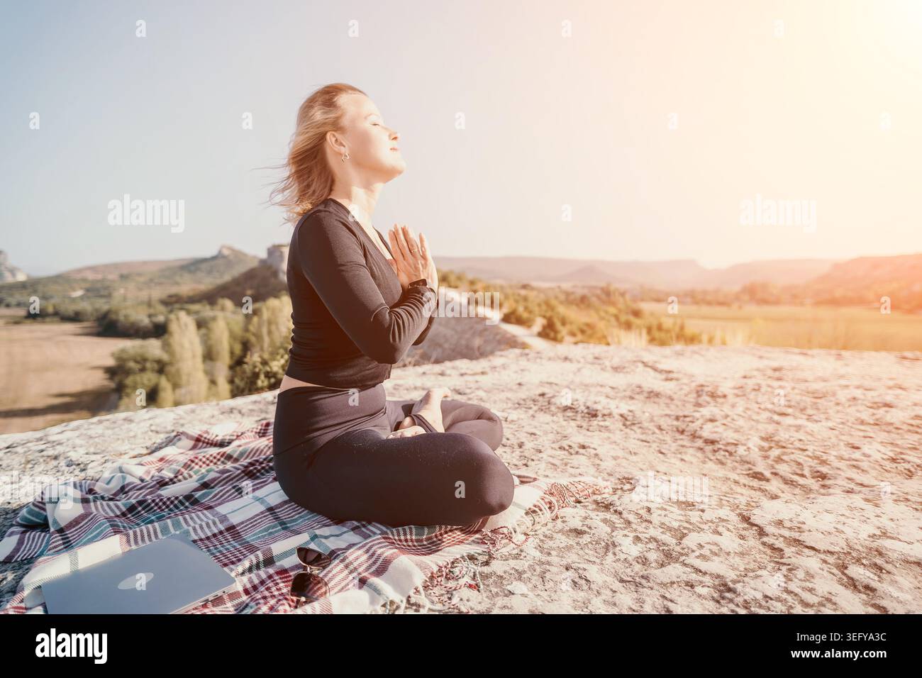 Woman Meditating on a Mountaintop Stock Photo