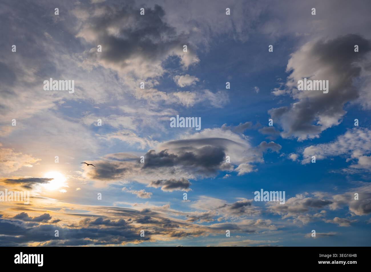 Sun in the sky at sunset, cloudscape natural background. Stock Photo