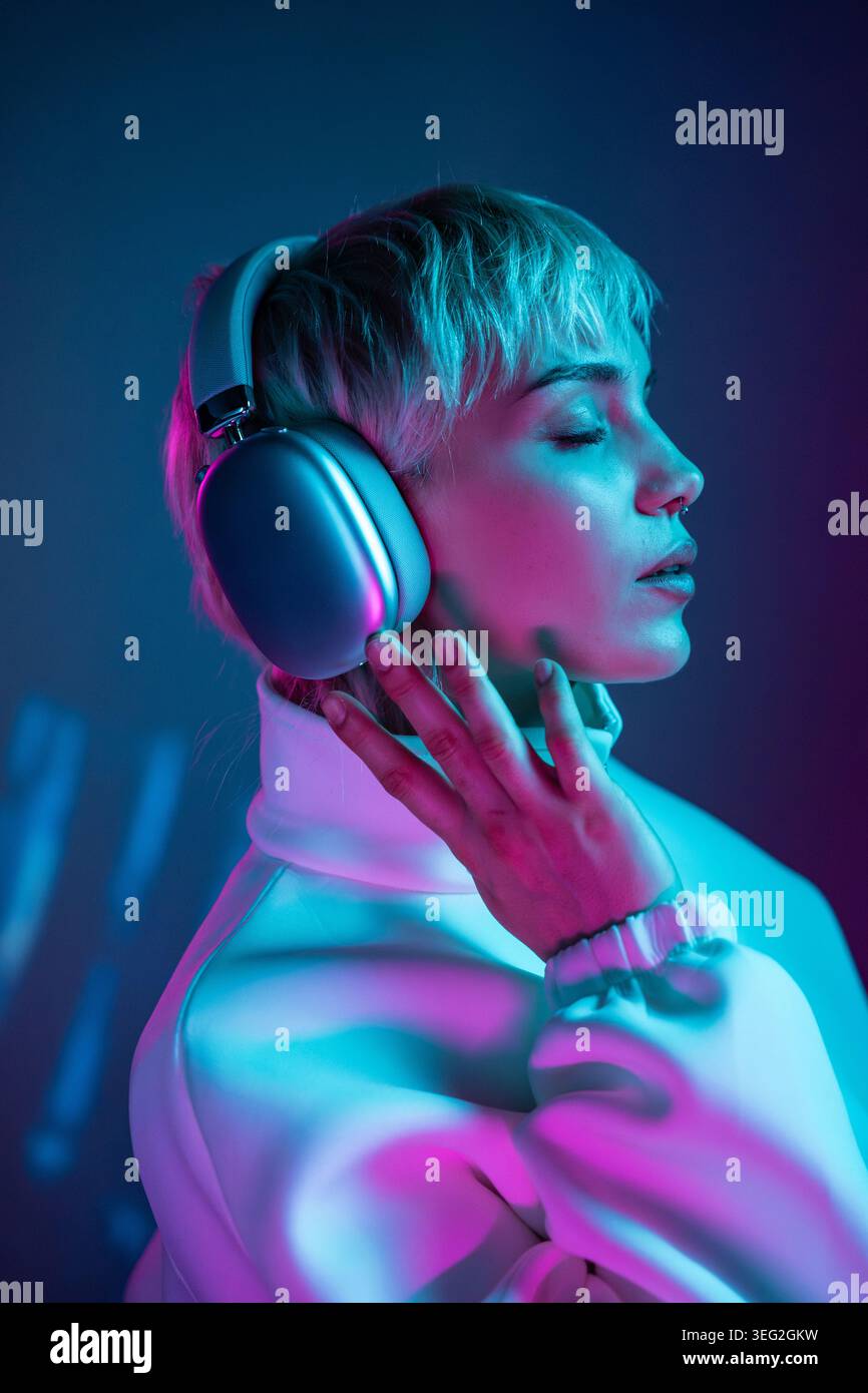 Side profile woman wearing headphones hi-res stock photography and