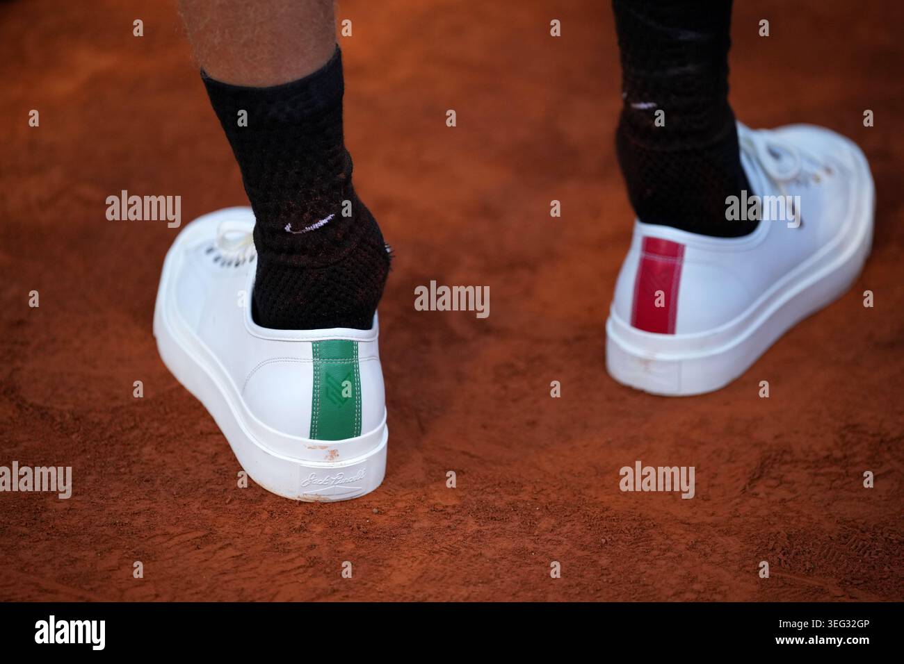 Jannik Sinner, of Italy, wears shoes in the Italian flag colors after ...