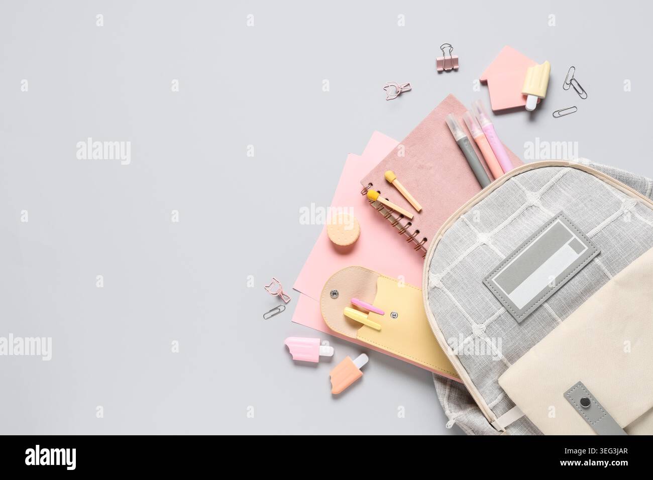 Stylish school backpack and different stationery on grey background Stock Photo