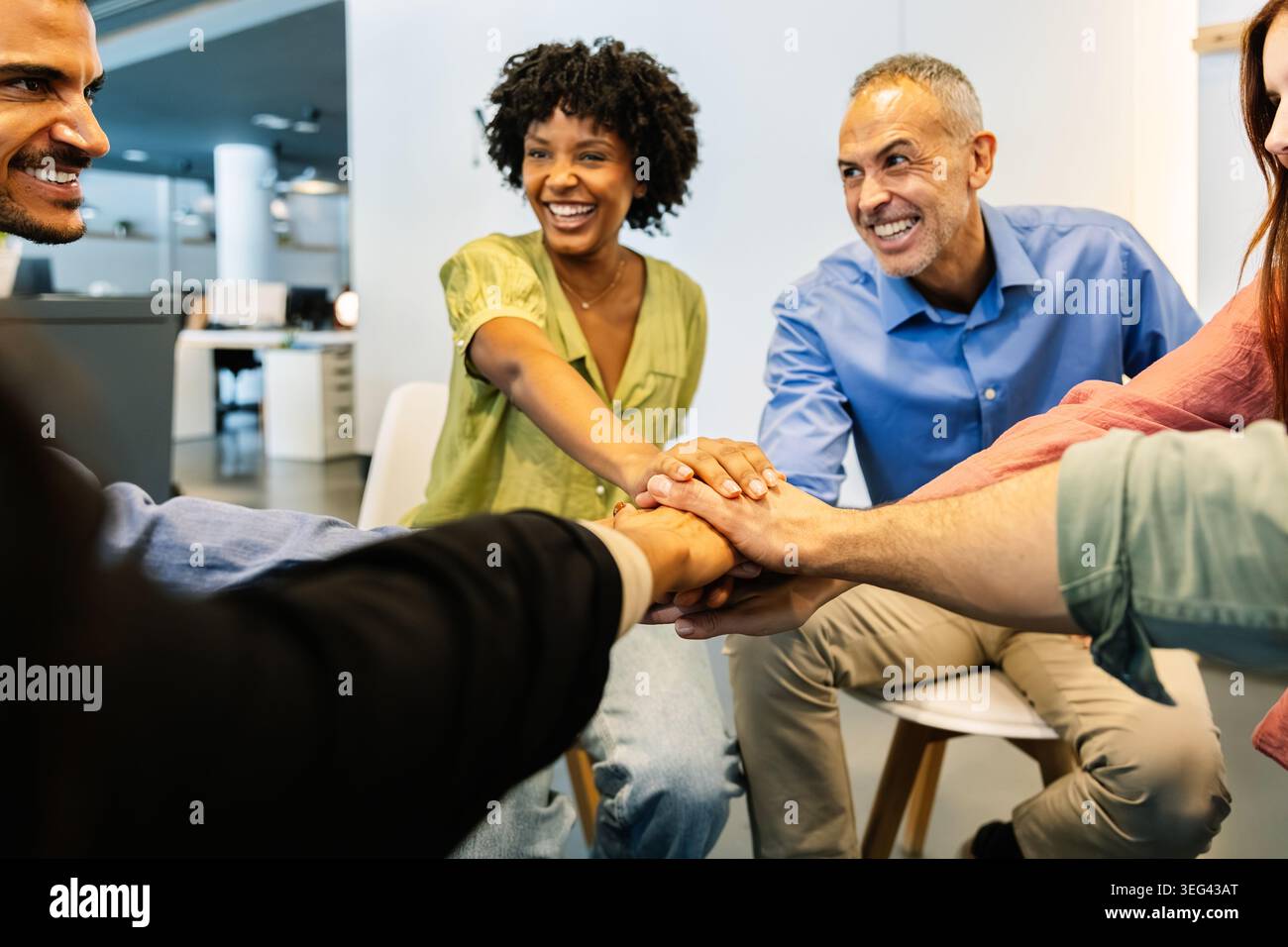 Diverse business team stacking hands for collaboration Stock Photo