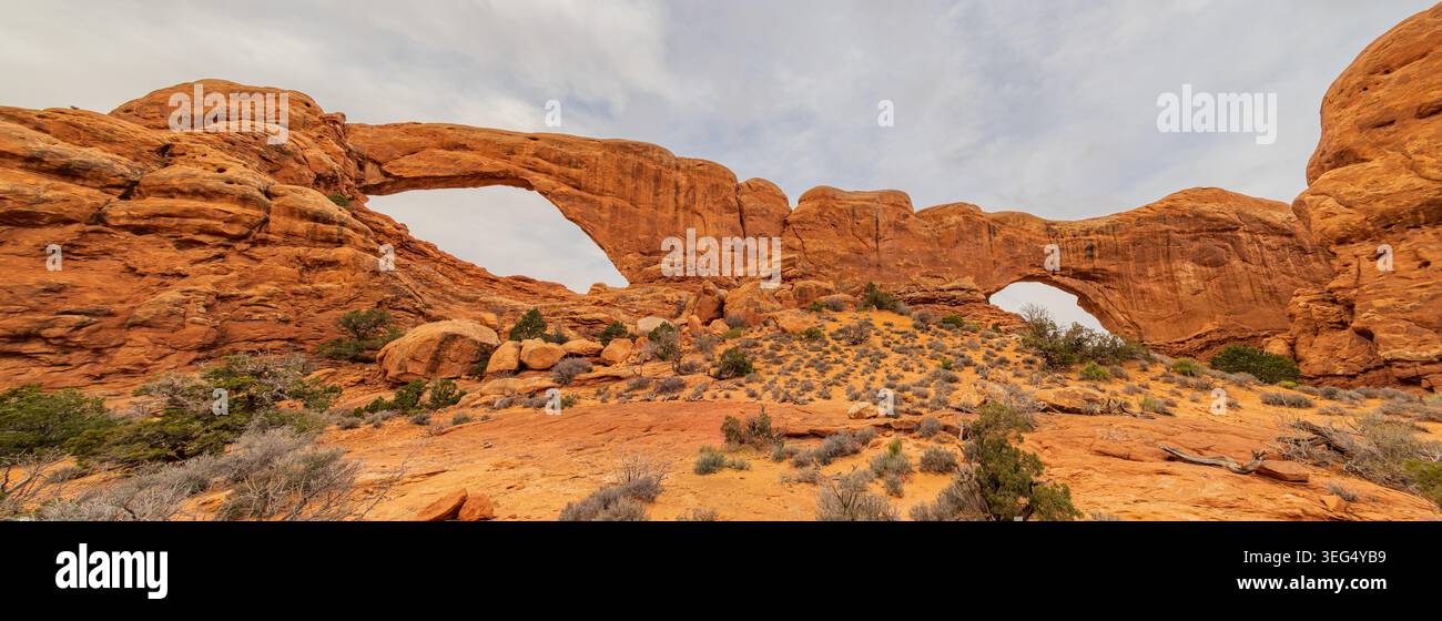 Ancient sandstone arches of prominent rocks stand majestically in a ...