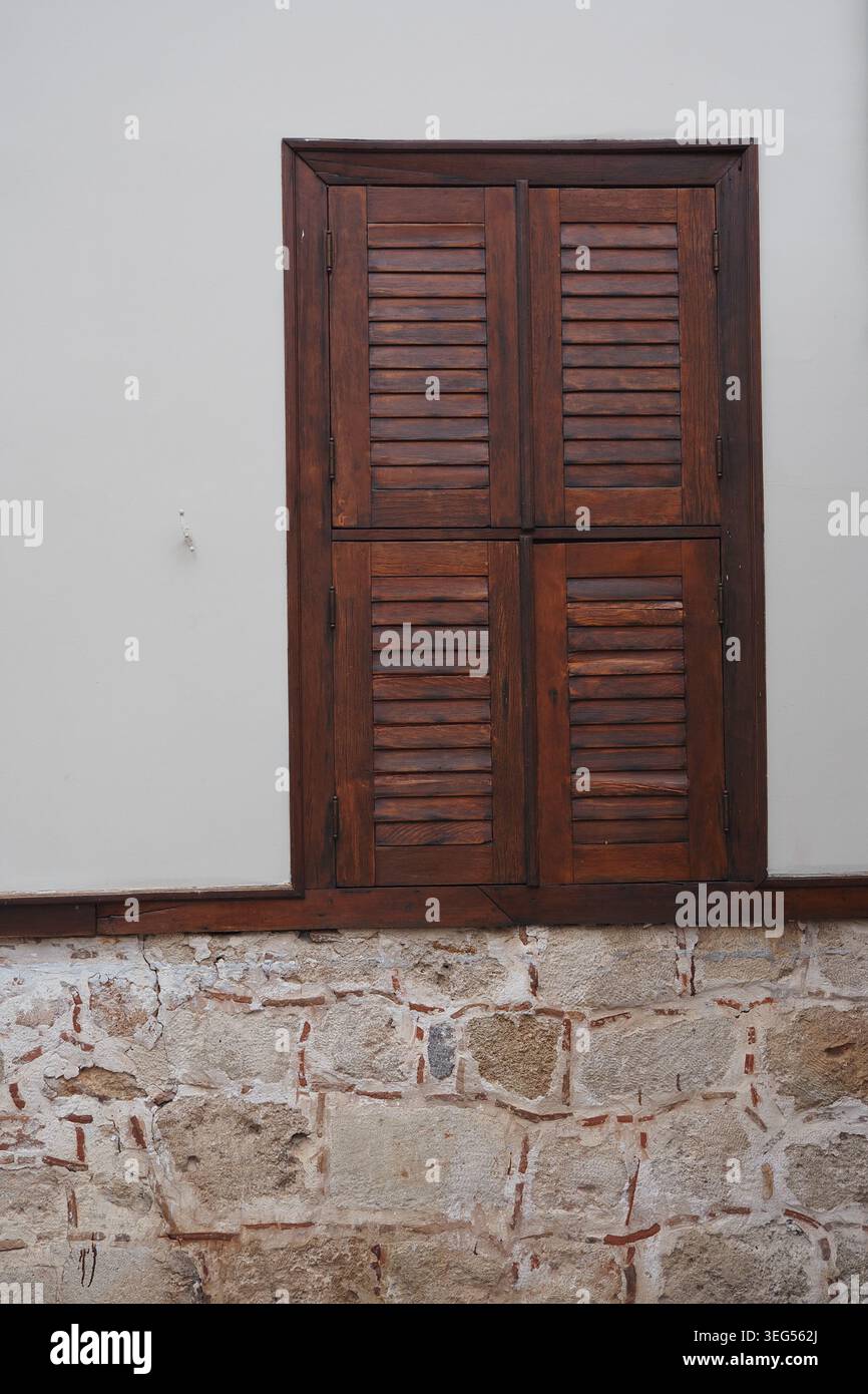 Wooden shutters on a stone wall in a building Stock Photo