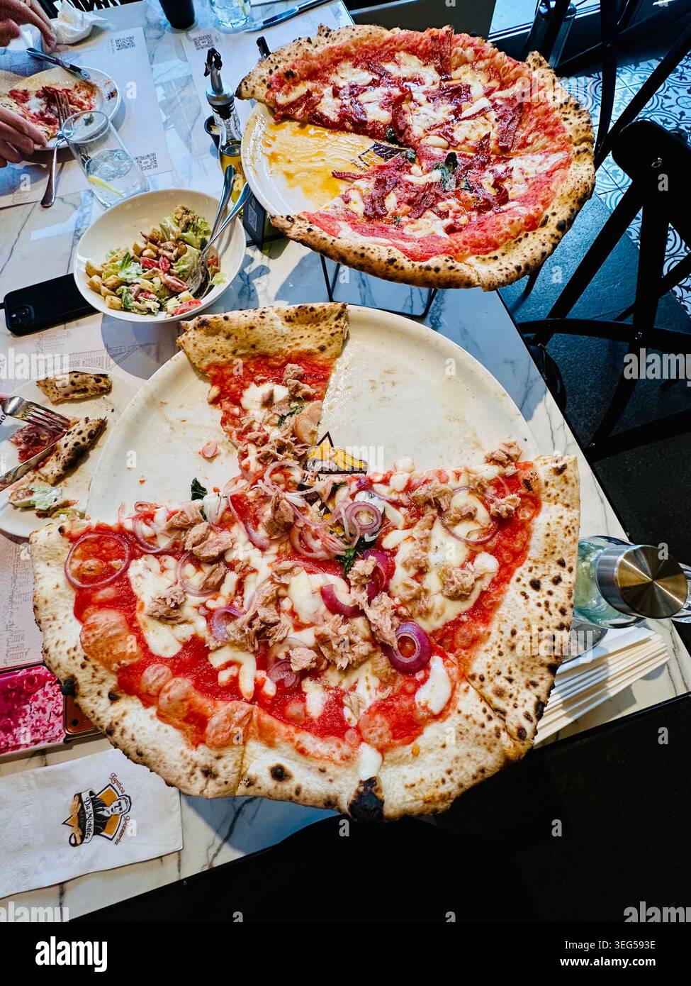 Pizzas on restaurant table Stock Photo