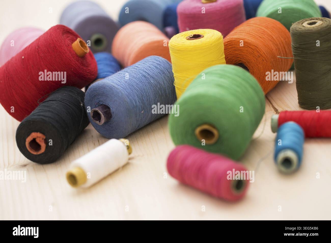 Tailoring. Many colorful threads on the table Stock Photo