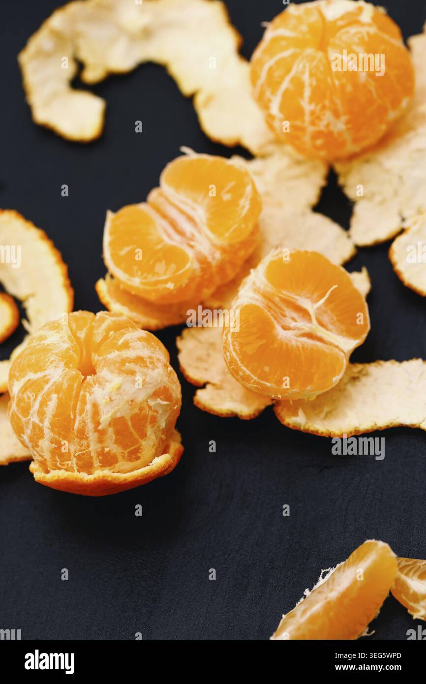 Shelled mandarins on a black background Stock Photo