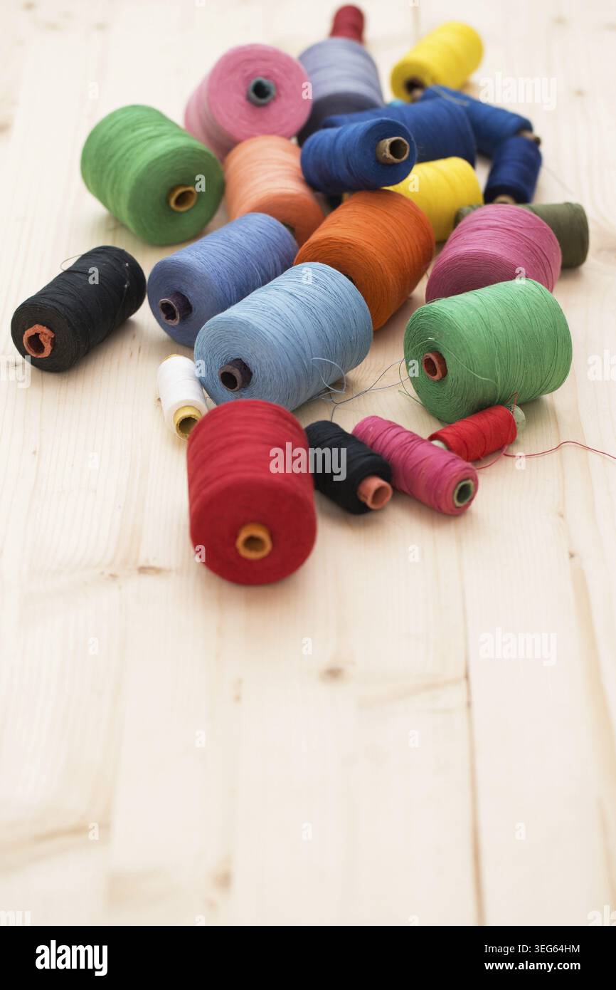 Tailoring. Many colorful threads on the table Stock Photo
