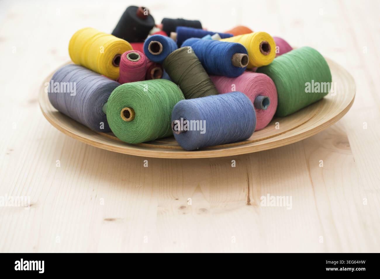 Tailoring. Many colorful threads on the table Stock Photo
