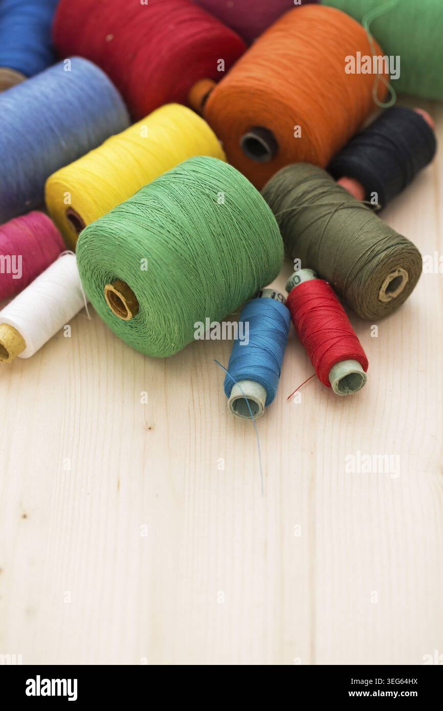 Tailoring. Many colorful threads on the table Stock Photo