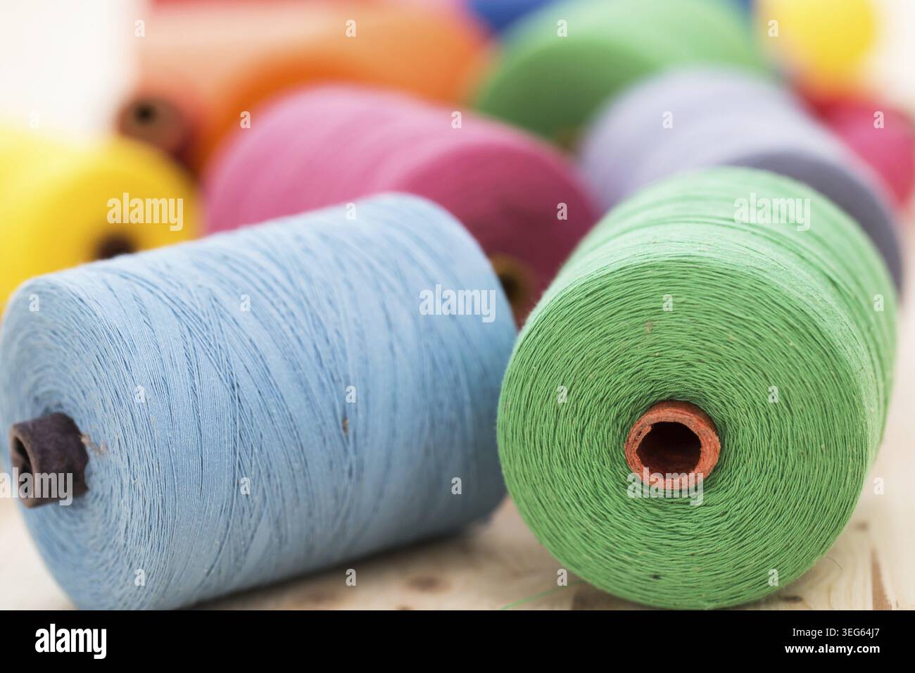 Tailoring. Many colorful threads on the table Stock Photo