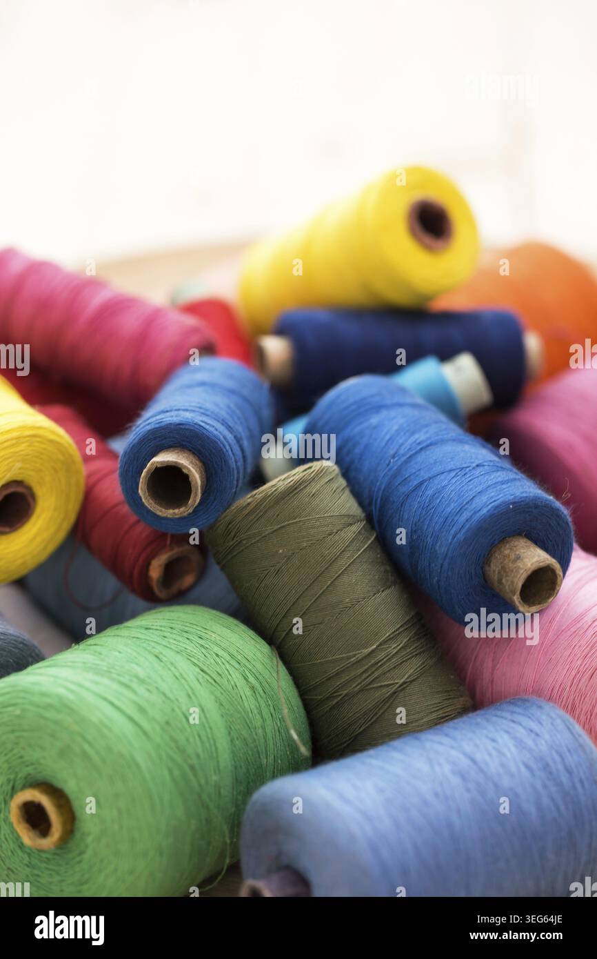 Tailoring. Many colorful threads on the table Stock Photo