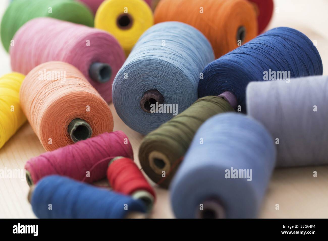 Tailoring. Many colorful threads on the table Stock Photo