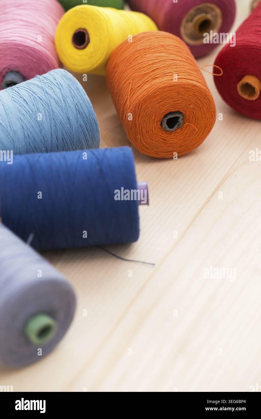 Tailoring. Many colorful threads on the table Stock Photo