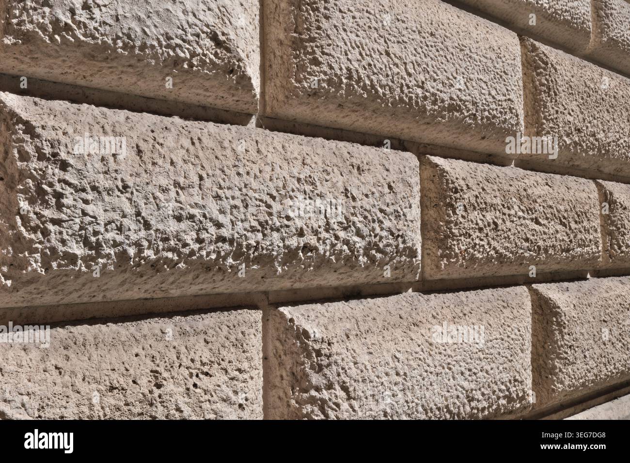 BACKGROUND TEXTURE OF A WALL WITH STONE BLOCK CLADDING Stock Photo