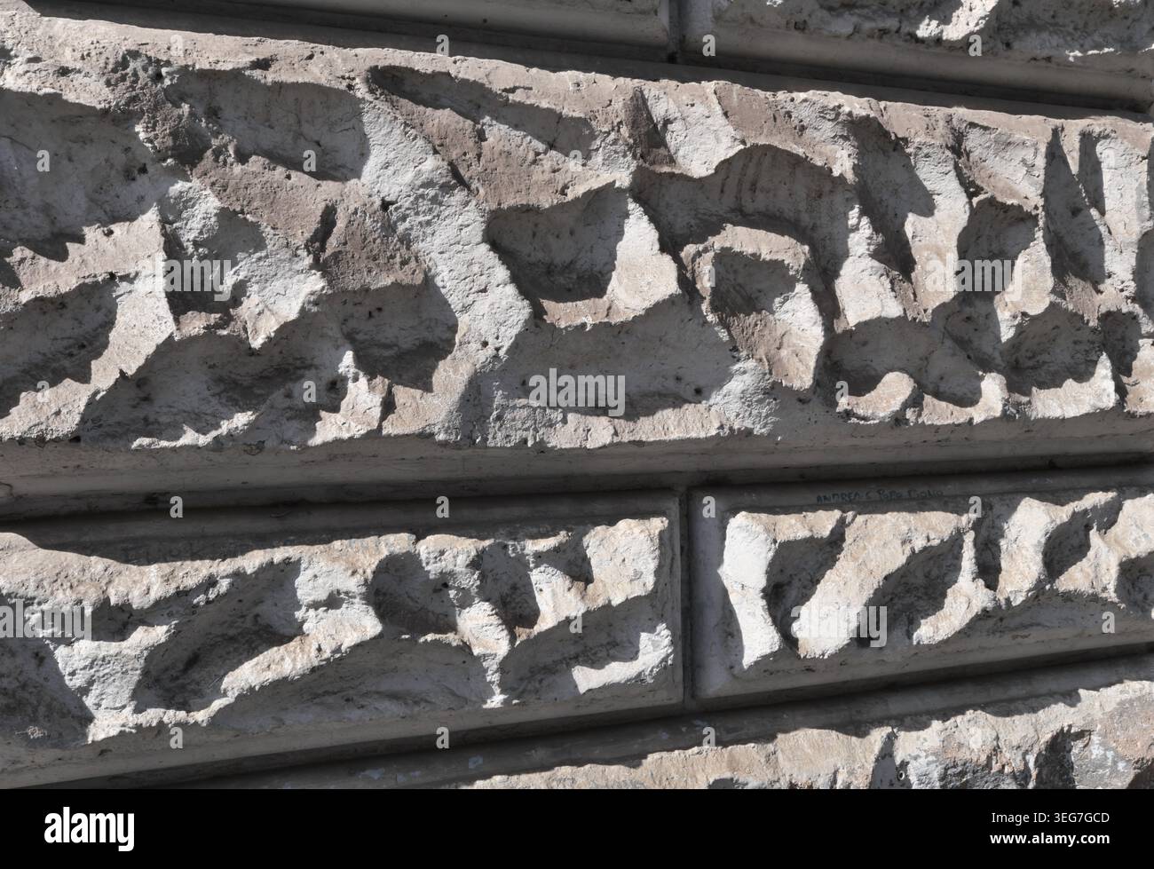 BACKGROUND TEXTURE OF A WALL WITH STONE BLOCK CLADDING Stock Photo