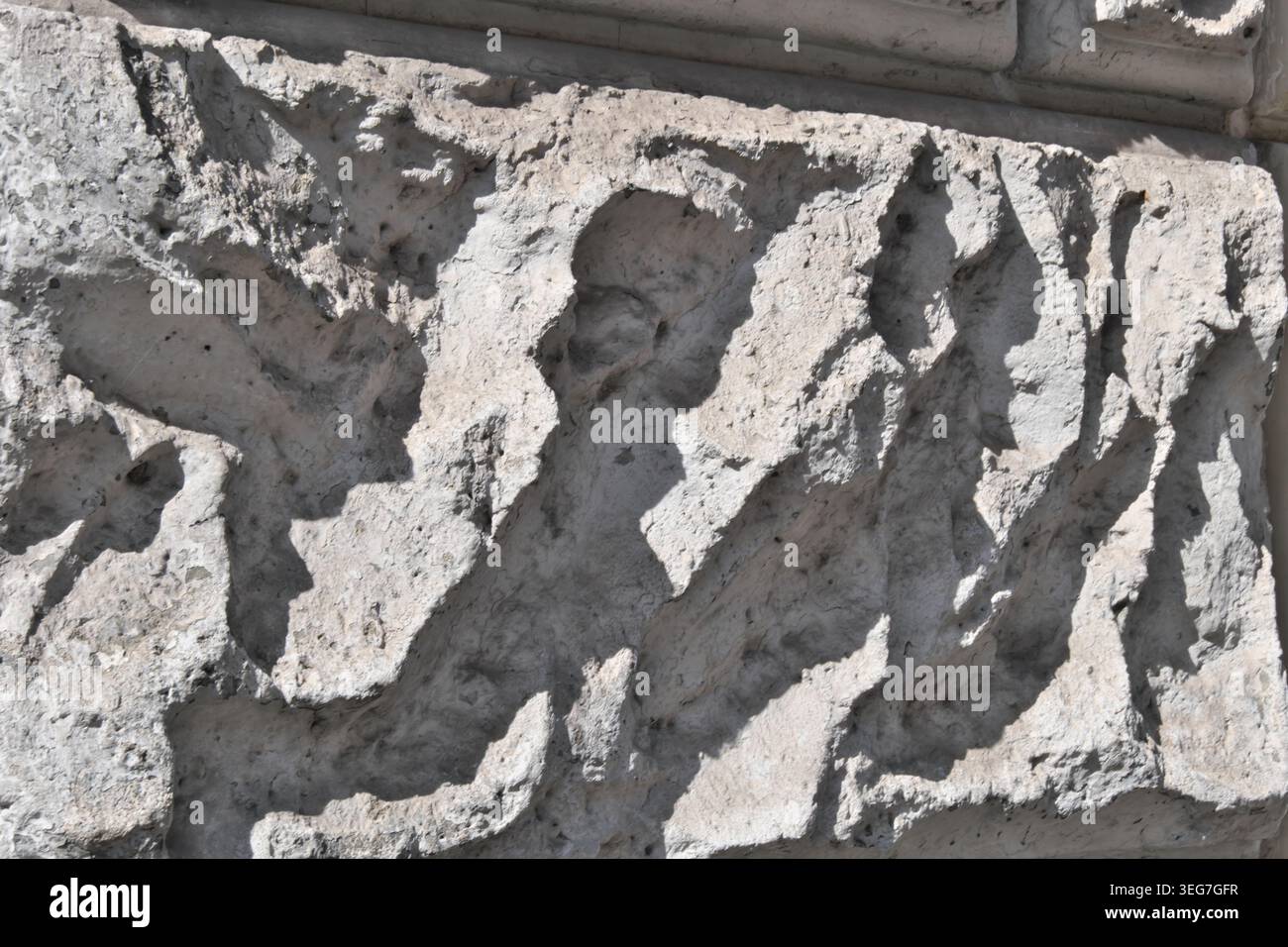 BACKGROUND TEXTURE OF A WALL WITH STONE BLOCK CLADDING Stock Photo