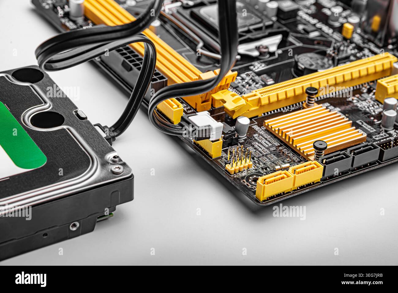 Hard drive connected to a computer motherboard. Stock Photo