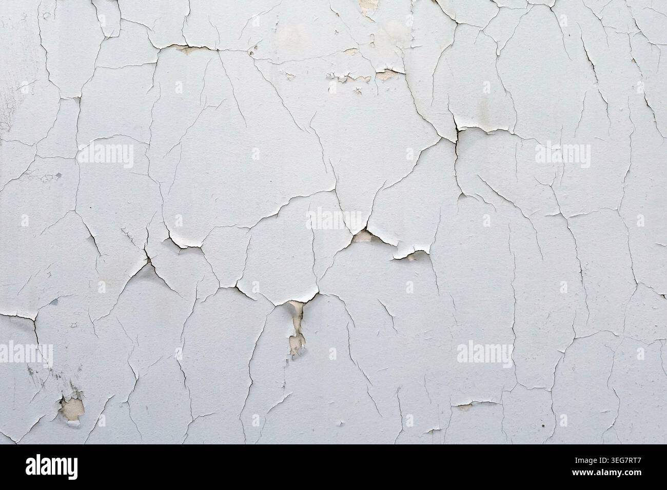 Cracked white wall chipped paint background with copyspace. Stock Photo