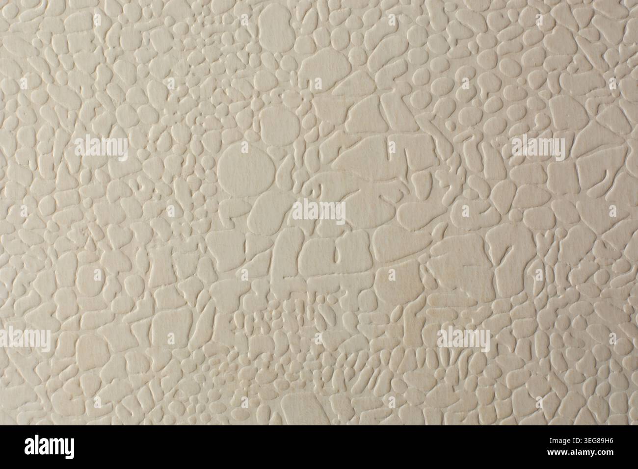 light cream embossed paper surface, raised irregular pebble pattern with matte finish, full frame background, graphic design backdrop texture Stock Photo
